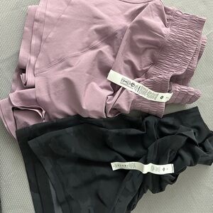 Two pair of shorts Purple and Black Athletic Shorts-preowned. Size 16 and XL.